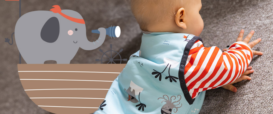 Baby crawling in blue pirate baby sleeping bag