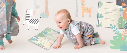baby crawling on floor in safari sleeping bag with feet