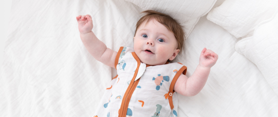 baby in a white baby sleeping bag with kangaroo print
